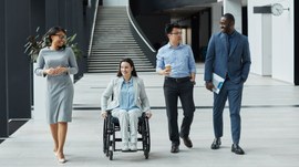 Foto de banco de imagens na qual um grupo de profissionais caminha por um corredor moderno, em a...