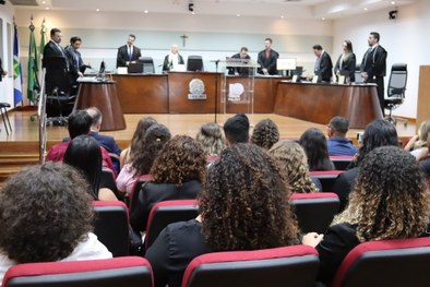 A imagem mostra uma estudante vendo os artefatos dentro do Memorial da Justiça Eleitoral